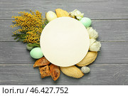 Blank card with flowers, eggs and treats on dark wooden background. Novruz Bayram celebration. Стоковое фото, фотограф Pixel_shot / Фотобанк Лори