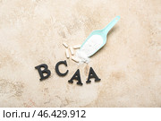 Letters BCAA, amino acid pills and powder on grunge background. Стоковое фото, фотограф Pixel_shot / Фотобанк Лори