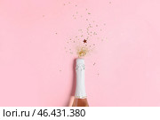 Bottle of champagne and glitters on color background. New Year celebration. Стоковое фото, фотограф Pixel_shot / Фотобанк Лори