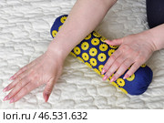 Women's palms on a needle roller - foot massage using an applicator Kuznetsov, Russia. Стоковое фото, фотограф Володина Ольга / Фотобанк Лори