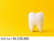Dental implant, toothache concept on yellow background. Стоковое AI-изображение, AI-художник Станислав Тарко / Фотобанк Лори