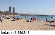Summer view of lively popular Barceloneta beach with two modern skyscrapers rising in background on sunny day (2022 год). Редакционное видео, видеограф Яков Филимонов / Фотобанк Лори