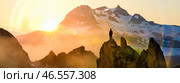Man standing on mountain peak at sunrise looking at peaks, success motivation goal achievement freedom adventure strength victory inspiration, breathtaking scenery high altitude. Стоковое фото, фотограф Павел Муравьев / Фотобанк Лори