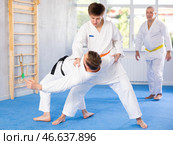 Young guy working on martial arts skills in training fight with male rival. Стоковое фото, фотограф Яков Филимонов / Фотобанк Лори