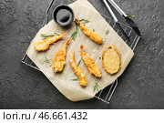 Охлаждающая подставка с вкусными креветками и соусом на темном фоне. Стоковое фото, фотограф Pixel_shot / Фотобанк Лори