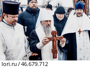 Saint Petersburg, Russia, 19 January 2022, Priest consecrate water, hold cross. Редакционное фото, фотограф Spirit River / Фотобанк Лори
