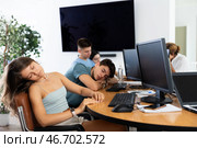 Tired young female employee engaged in programming dozing off at workplace. Стоковое фото, фотограф Яков Филимонов / Фотобанк Лори