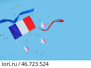 Флаг Франции со звездами и лентами на синем фоне. Празднование Дня взятия Бастилии. Стоковое фото, фотограф Pixel_shot / Фотобанк Лори