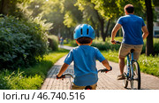 A cheerful little boy rides a bicycle in a helmet outdoors. A happy child is engaged in an active sport. Protection. Life insurance and child safety. Стоковое AI-изображение, AI-художник Photojuli / Фотобанк Лори