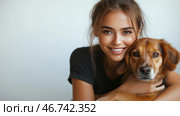 Smiling woman cuddles her dog in a cozy indoor setting. Стоковое AI-изображение, AI-художник Katsiaryna Repich / Фотобанк Лори