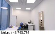 Modern compact office room with several workstations and bright artificial light. Стоковое фото, фотограф David Kashakhi / Фотобанк Лори