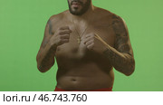 Man standing in battle stance and boxing. Стоковое фото, фотограф David Kashakhi / Фотобанк Лори