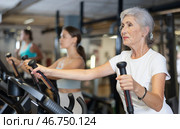 Elderly woman training on an elliptical machine. Стоковое фото, фотограф Яков Филимонов / Фотобанк Лори