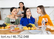 Sad Caucasian woman sits silently in kitchen, female friends sympathize and comfort woman. Стоковое фото, фотограф Яков Филимонов / Фотобанк Лори