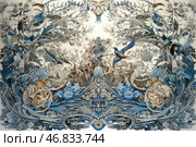 A complex decorative composition made in the style of elegant graphics with ornamental elements. The basis of the composition is plants, flowers, birds and natural motifs intertwined in a symmetrical pattern. The work is dominated by cold shades - blue, light blue, gray - which create an effect of sophistication and depth. Birds soar among the foliage, their movements convey a sense of life and dynamics. In the center are decorative elements, possibly symbolizing natural harmony and cyclicality. The illustration is filled with details, fine lines and complex patterns, which gives it a luxurious and classic look. Стоковое AI-изображение, AI-художник Анна Кривицкая / Фотобанк Лори