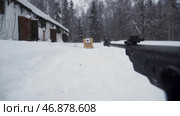 The shooter in camouflage targets a target with a rifle with an optical sight, focus on weapons. Стоковое фото, фотограф David Kashakhi / Фотобанк Лори