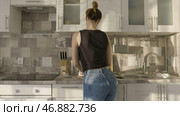 Sexy woman dancing marinating chicken in home kitchen. Стоковое фото, фотограф David Kashakhi / Фотобанк Лори