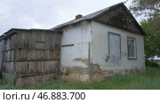 An old, abandoned house in the village, on a background of trees. Стоковая иллюстрация, иллюстратор David Kashakhi / Фотобанк Лори