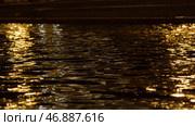 Close up of moving water surface with the reflection of lantern lights. Стоковое фото, фотограф David Kashakhi / Фотобанк Лори
