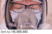 Scientist in protective clothing with respirator. Стоковое фото, фотограф David Kashakhi / Фотобанк Лори