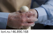 Close up for hands of a cheesemaker cutting mozzarella with hands, traditional food concept. Стоковое фото, фотограф David Kashakhi / Фотобанк Лори