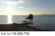 Old sunk boat near sea shore on big mountain and blue sky background. Стоковое фото, фотограф David Kashakhi / Фотобанк Лори