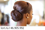 Elegant woman sporting a sophisticated chignon hairstyle. Стоковое AI-изображение, AI-художник Юрий Поздников / Фотобанк Лори