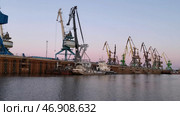 Big industrial machines and calm water surface, concept of goods transportations. Стоковое фото, фотограф David Kashakhi / Фотобанк Лори