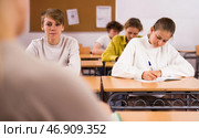 School lesson - students write down assignments while sitting at desks. Стоковое фото, фотограф Яков Филимонов / Фотобанк Лори