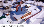 View of a small village, you can see fenced private houses and a lot of snowdrifts nearby. Стоковое фото, фотограф David Kashakhi / Фотобанк Лори