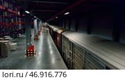 Unloading trains with goods and placing them on special warehouse shelves. Стоковое фото, фотограф David Kashakhi / Фотобанк Лори