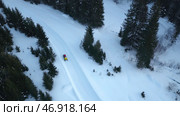 Snowmobile with headlight rides in evening in forest in winter. Стоковое фото, фотограф David Kashakhi / Фотобанк Лори