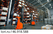 Madrid-Spain, October 8, 2022: Creative.A large bright warehouse with working equipment where the packed ordered goods are laid out. Редакционное фото, фотограф David Kashakhi / Фотобанк Лори
