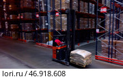 A large order store where people work collecting and packaging boxes. Редакционное фото, фотограф David Kashakhi / Фотобанк Лори
