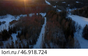 Clip.Helicopter view of green almost leafless trees and snow drifts around with a blue sky. Стоковое фото, фотограф David Kashakhi / Фотобанк Лори