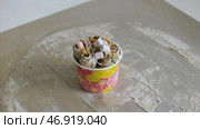 ice cream rosettes, topped with all manner of over-the-top ingredients. Стоковое фото, фотограф David Kashakhi / Фотобанк Лори