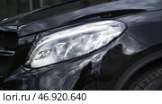 Exterior detail, headlight of a prestigious vehicle, luxury concept. Стоковое фото, фотограф David Kashakhi / Фотобанк Лори