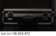 Unknown shining object lying inside an opened mysterious carrying case. Стоковое фото, фотограф David Kashakhi / Фотобанк Лори