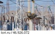 Electric substation with powerful equipment and transformers working in winter. Стоковое фото, фотограф David Kashakhi / Фотобанк Лори