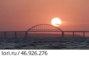 Stunning view of the beautiful sunset over the big river and the bridge, time lapse effect. Стоковое фото, фотограф David Kashakhi / Фотобанк Лори