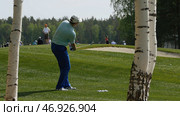 Golfers hit sweeping golf course in the summer. Стоковое фото, фотограф David Kashakhi / Фотобанк Лори