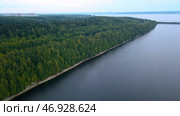 A huge black sea where you can see the coast and the forest, a transport bridge and calm clouds. Стоковое фото, фотограф David Kashakhi / Фотобанк Лори