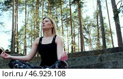 Happy woman deeply connected with nature feels unity and meditating in forest outdoors. Стоковое фото, фотограф David Kashakhi / Фотобанк Лори