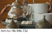Traditional tea service with silver teapot and sugar sweets in a cozy cafe setting. Стоковое видео, видеограф Сергей Толмачёв / Фотобанк Лори