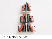 Креативная композиция с книгами на полках на светлой стене. Стоковое фото, фотограф Pixel_shot / Фотобанк Лори