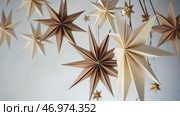 Christmas Paper Star and Ball Decoration. Handmade Christmas Nordic Decor on a Light Background against the Wall. Boho, Scandinavian Style Design. DIY. Minimal Ornament. Structural Origami. Zero Waste. Стоковое AI-видео, аниматор Марина Демидюк / Фотобанк Лори