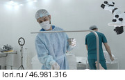 Portrait of a surgeon preparing for the procedure at work in a hospital. Стоковое фото, фотограф David Kashakhi / Фотобанк Лори