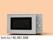 Белая микроволновая печь с открытой дверцей на бежевом фоне. Стоковое фото, фотограф Pixel_shot / Фотобанк Лори