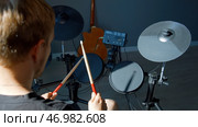 Unrecognizable musician hands hitting drum plates in recording studio. Стоковое фото, фотограф David Kashakhi / Фотобанк Лори