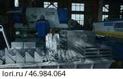 Worker assembles construction or machine in industrial plant according to details. Стоковое фото, фотограф David Kashakhi / Фотобанк Лори